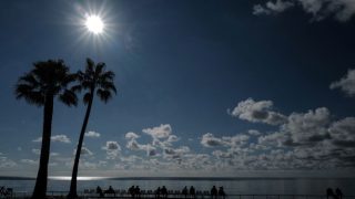 People look at the Mediterranean Sea on the "Promenade des anglais" in the French riviera city of Nice, on October 19, 2020. (Photo by Valery HACHE / AFP)