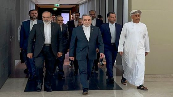In this handout photo obtained from Irans foreign ministry delegation on February 6, 2026, Irans Foreign Minister Abbas Araghchi (C) arrives for a meeting in Muscat. Iran and the United States began talks on February 6 in Oman, with Washington refusing to rule out military action against its foe if diplomacy fails while the Islamic republic vowed to defend itself against "any excessive demands". (Photo by IRAN FOREIGN MINISTRY / AFP) / NO USE AFTER FEBRUARY 15, 2026 22:00:00 GMT - RESTRICTED TO EDITORIAL USE - MANDATORY CREDIT "AFP PHOTO / IRAN FOREIGN MINISTRY" - HANDOUT - NO MARKETING NO ADVERTISING CAMPAIGNS - DISTRIBUTED AS A SERVICE TO CLIENTS